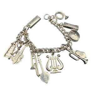 Orchestra charm bracelet vintage gold tone with 11 charms